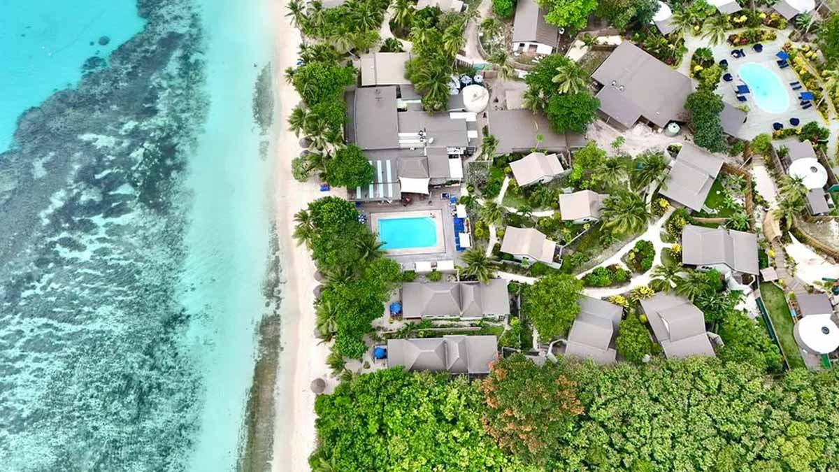 Aerial view of Blue Lagoon Beach Resort beside the beach and house reef