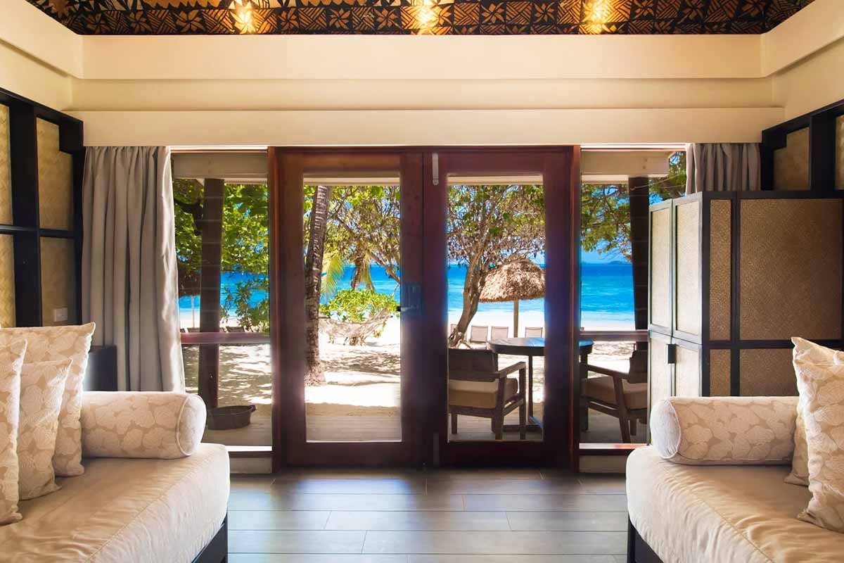 View from a North Beach Bure through its patio to the beach at Castaway Island Fiji