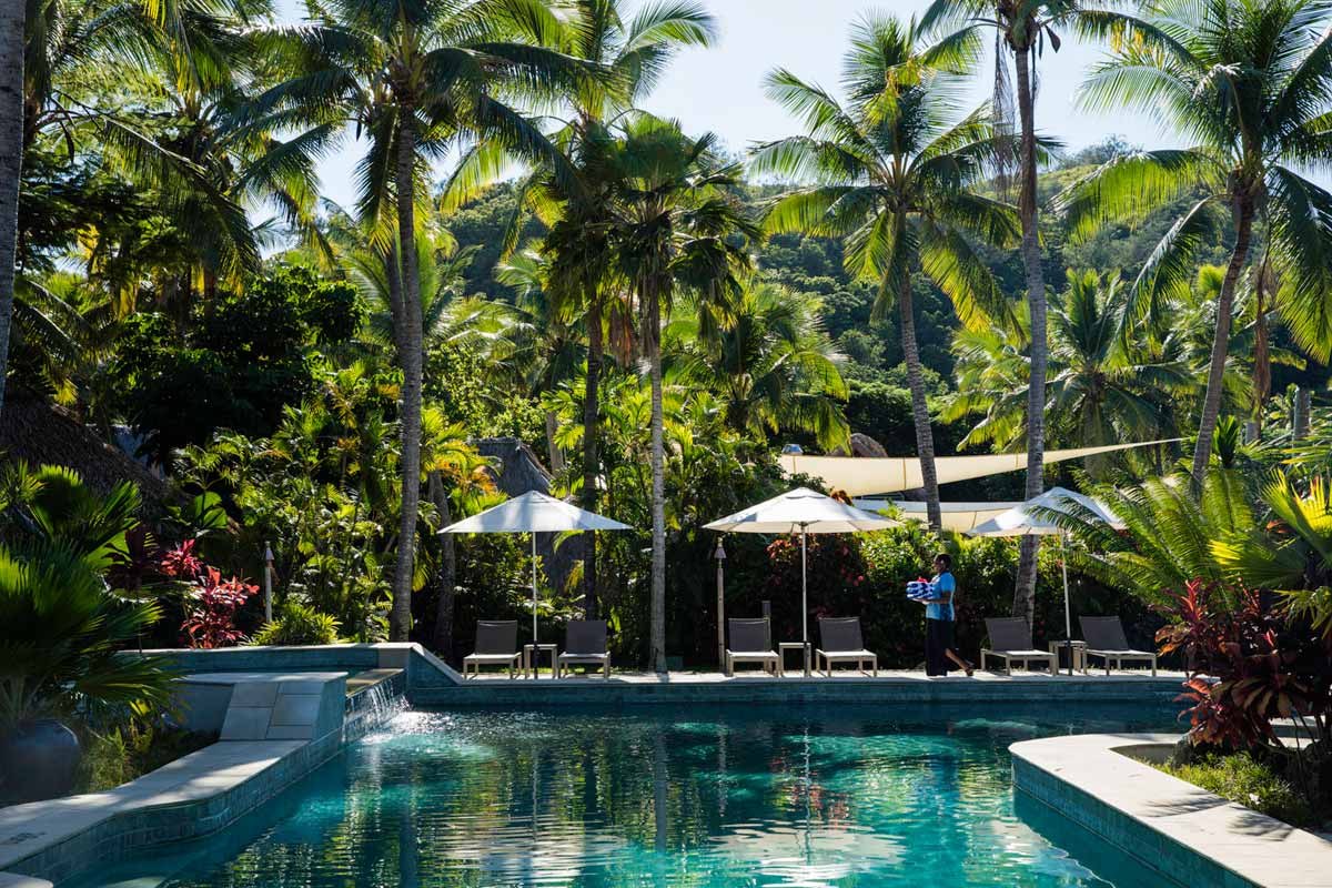 The quieter swimming pool surrounded by palms at Castaway Island Fiji