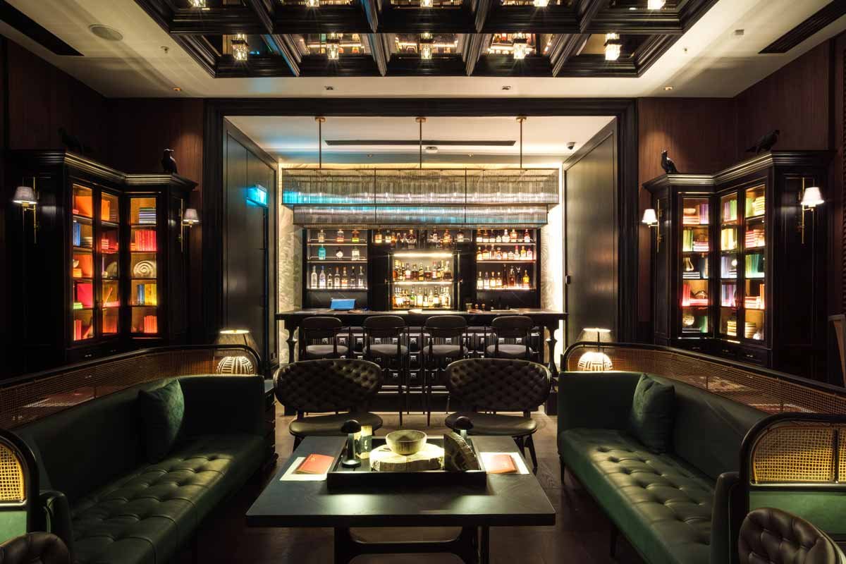 Intimate bar lounge with dark timber and comfortable seating at Crowne Plaza Fiji