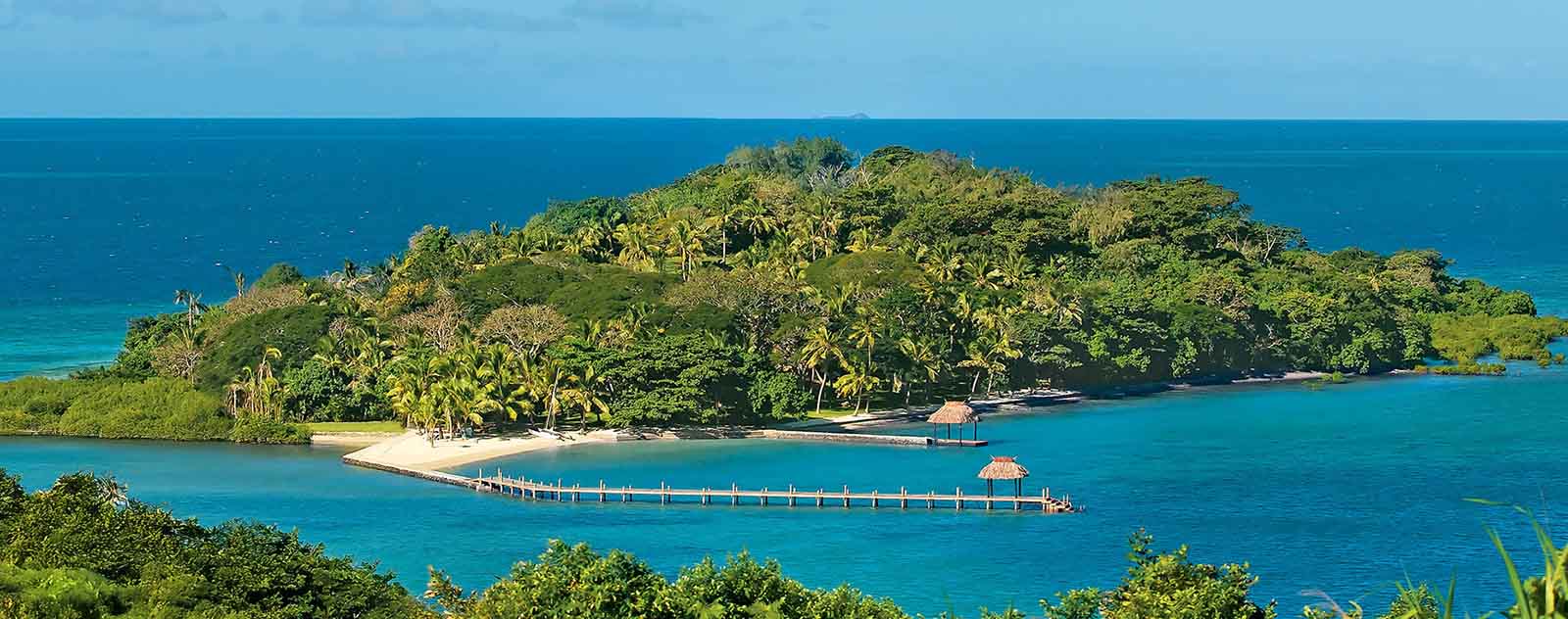 Dolphin Island and its jetty surrounded by blue water off northern Viti Levu