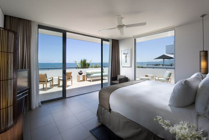 Hilton Fiji guest bedroom opening to a terrace and ocean outlook