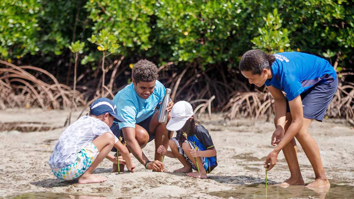 Children joining a guided mangrove planting activity at Jean-Michel Cousteau Resort