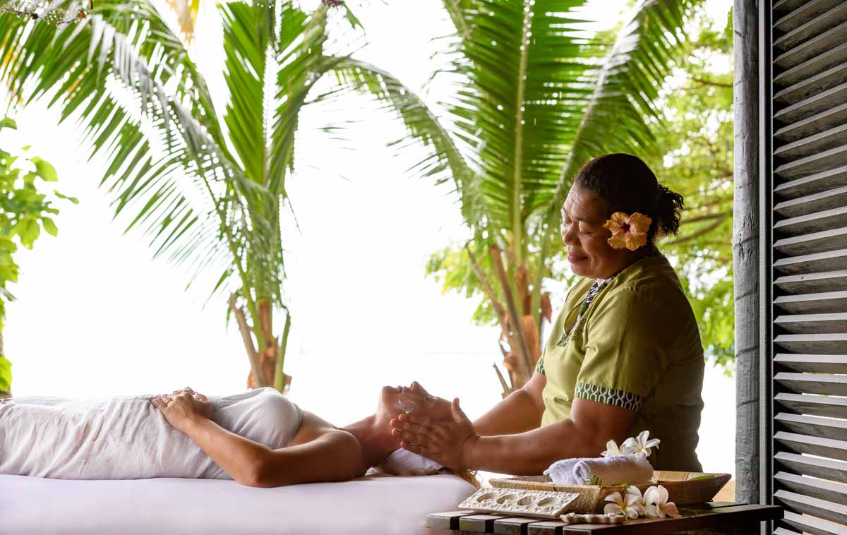 Massage treatment in a garden-facing spa setting at Jean-Michel Cousteau Resort
