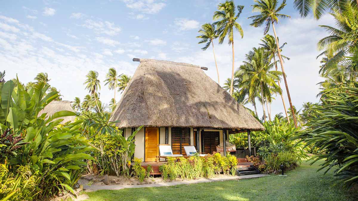 Thatched bure set among tropical gardens at Jean-Michel Cousteau Resort