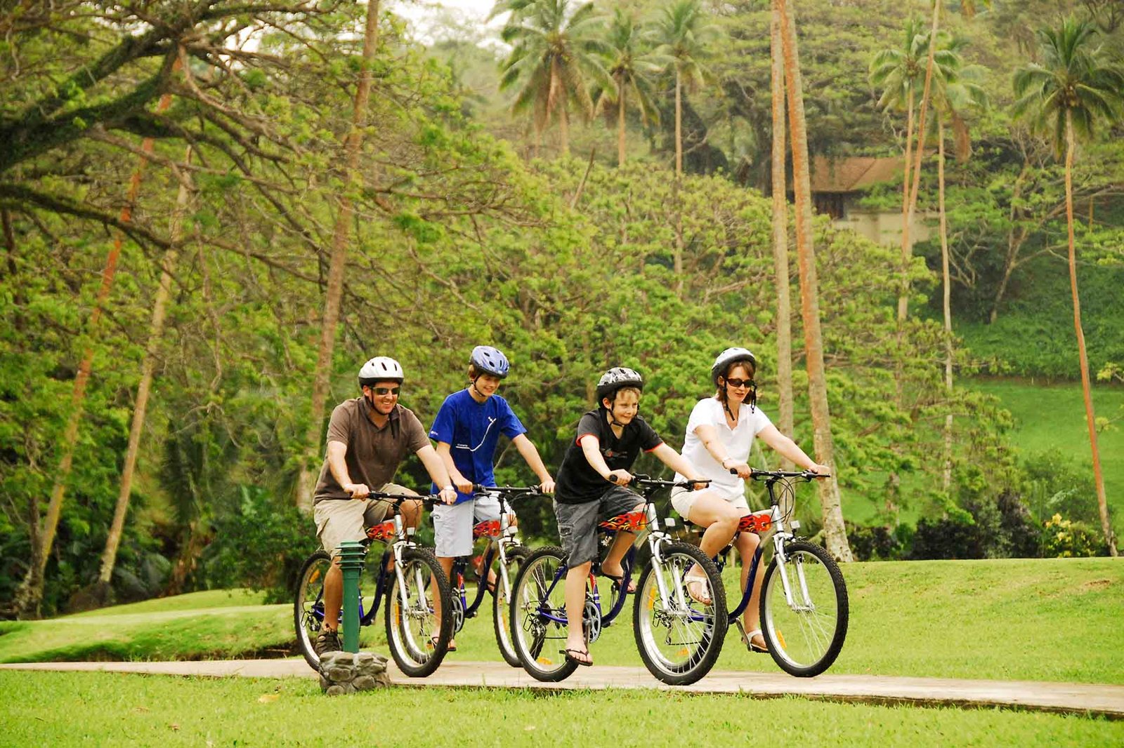 Family cycling among the gardens at Koro Sun Resort