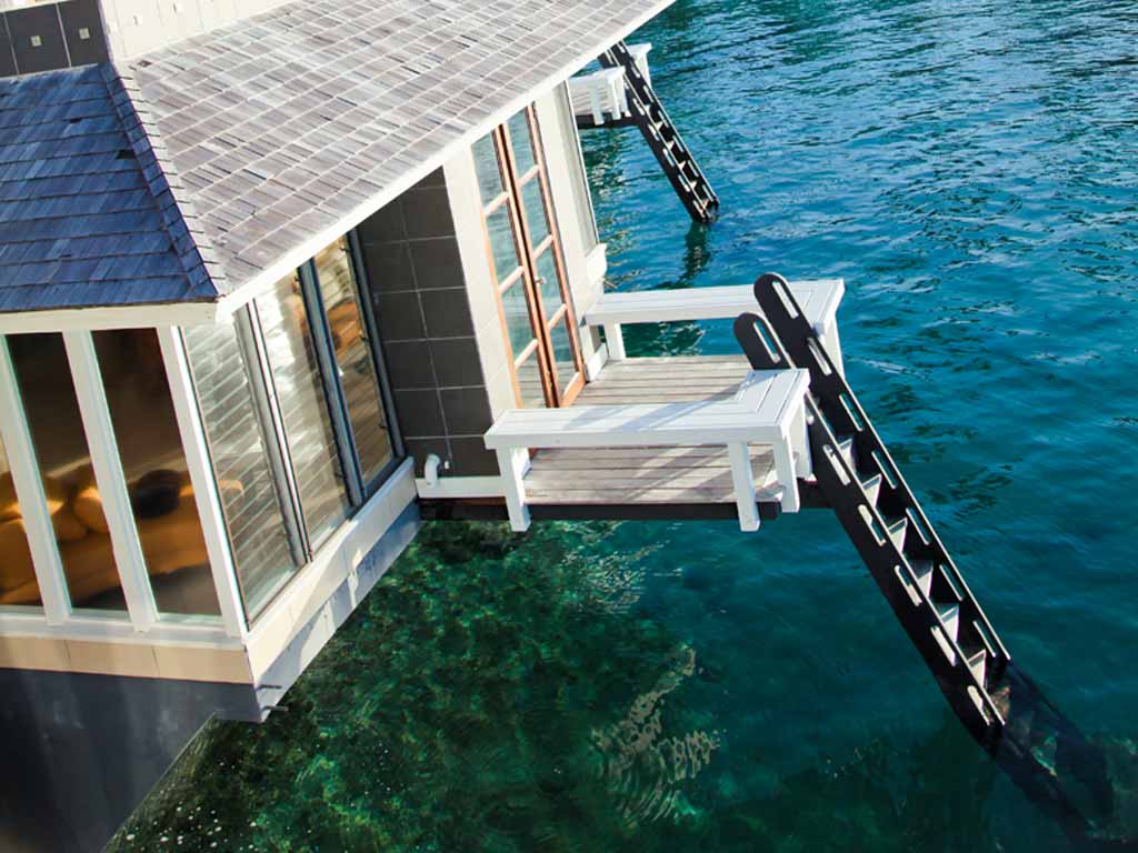 Deck and ladder above the water at a Koro Sun Floating Bure