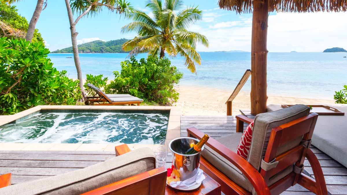 Private plunge pool and beachfront deck at a Deluxe Beachfront Bure at Likuliku Lagoon Resort