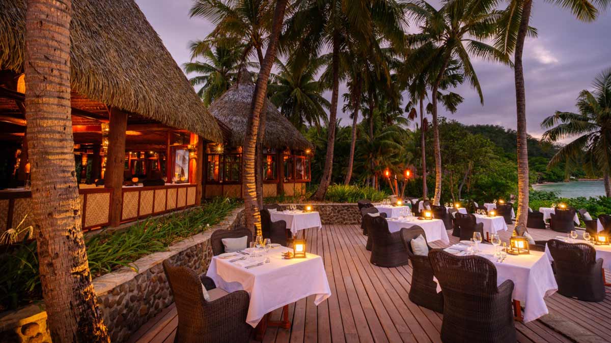 Evening dining on the restaurant terrace at Likuliku Lagoon Resort