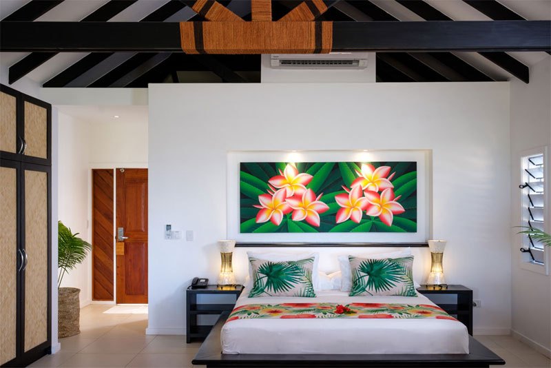 Beachfront Bure bedroom at Lomani Island Resort