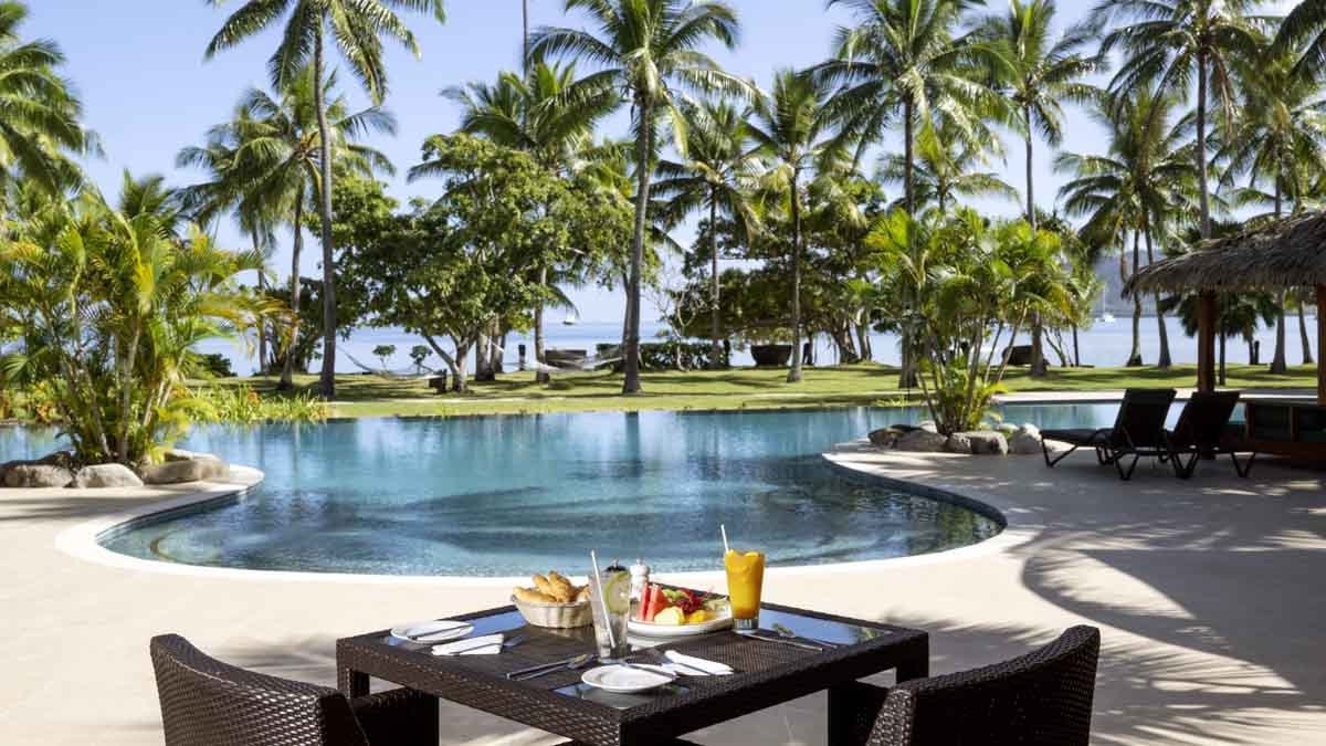 Breakfast table beside Lomani’s resort pool