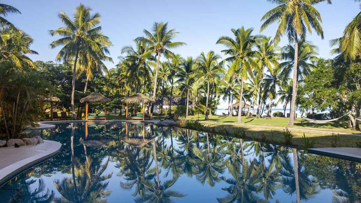 Palms reflected in Lomani’s resort pool
