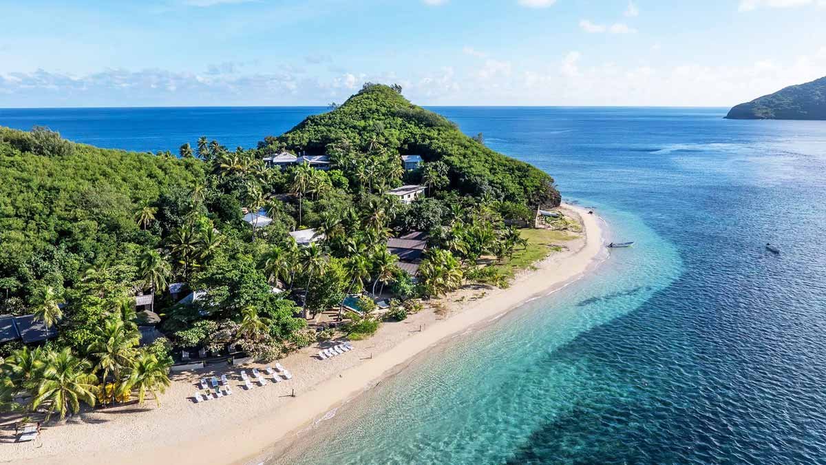 Mantaray Island Resort along a palm-lined beach beside the house reef