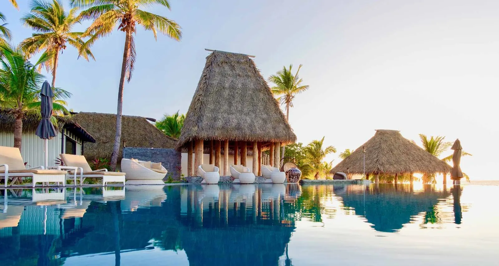 Infinity pool and thatched resort buildings at Matamanoa Island Resort