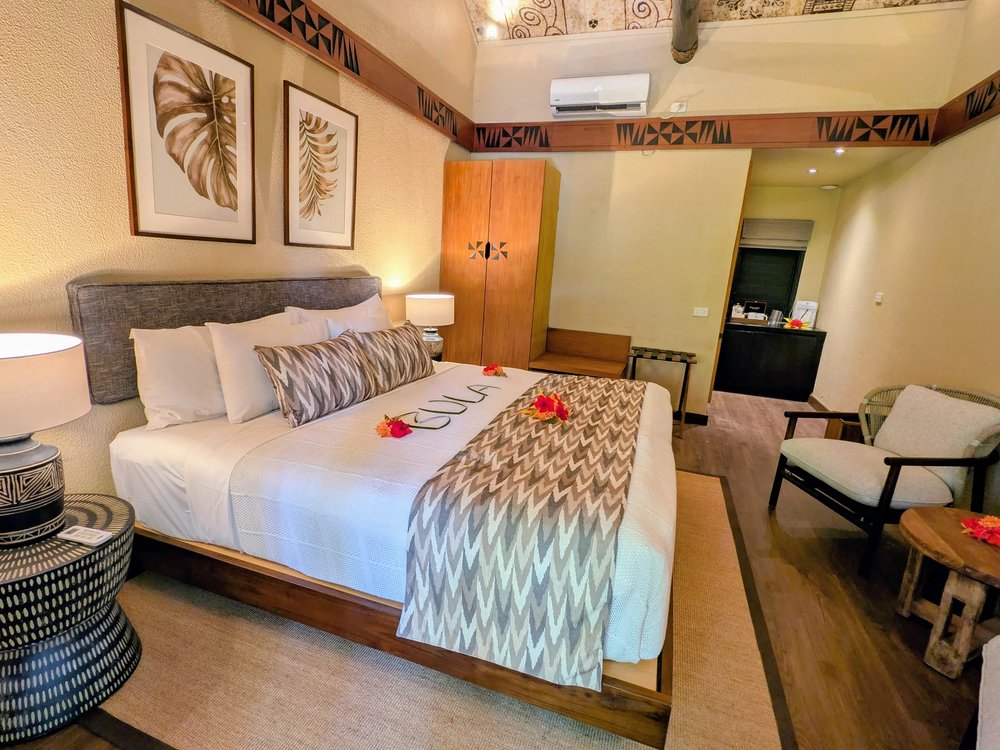 King bed and Fijian tapa detailing in a Matamanoa Island Room
