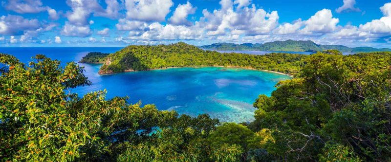 Turquoise Horseshoe Bay surrounded by forest on Matangi Island