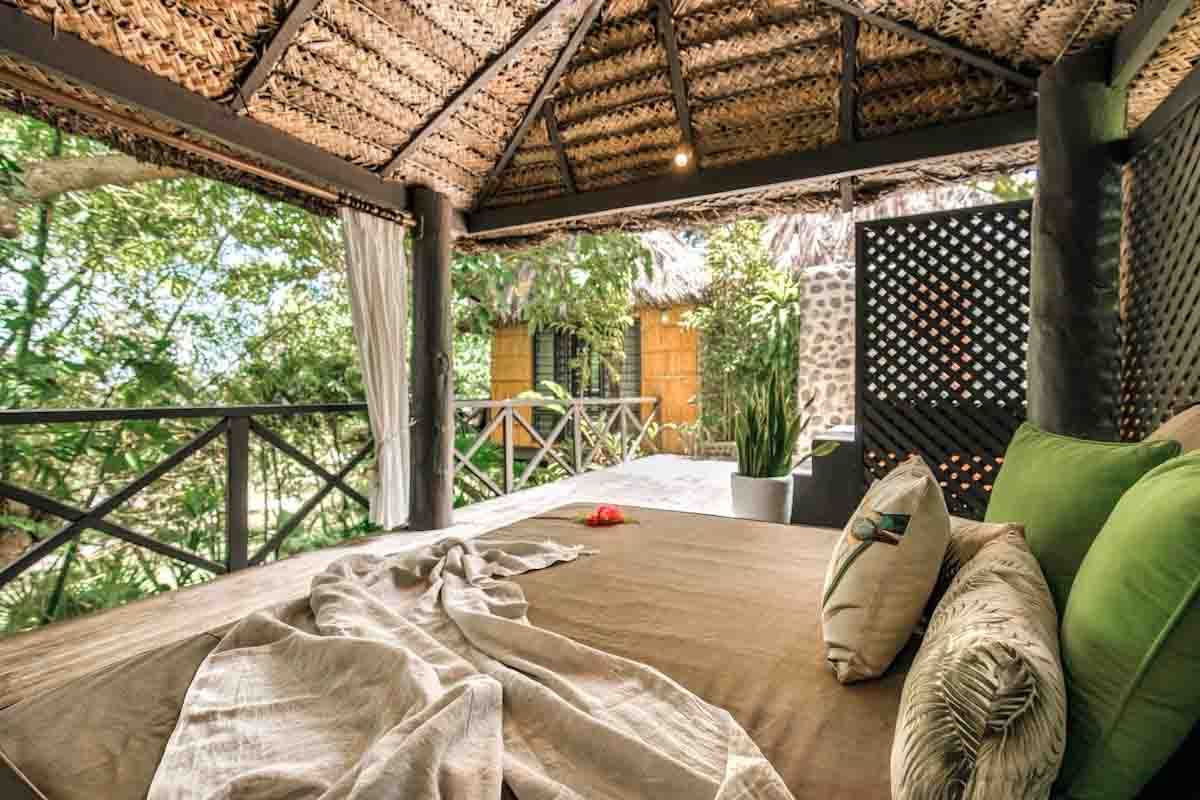 Sheltered daybed on a Matangi Luxury Treehouse Bure verandah