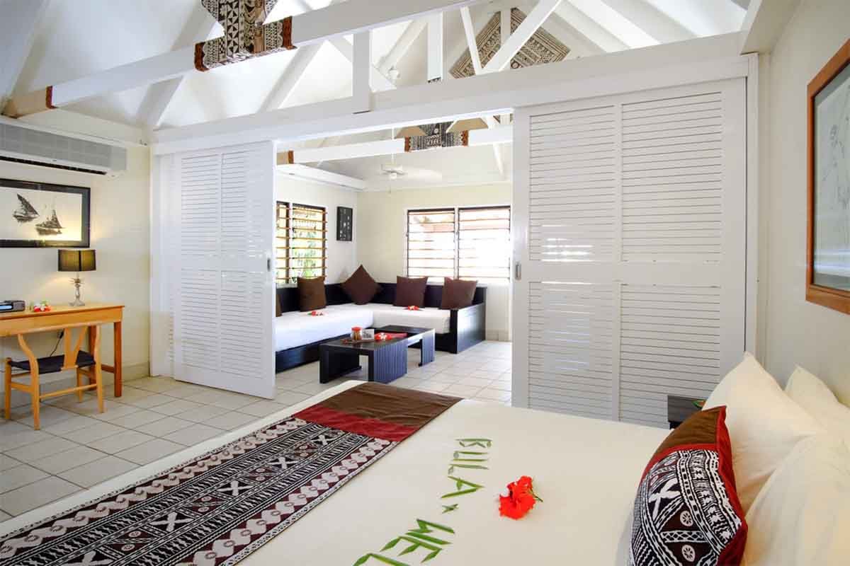 Garden Bure bedroom and living area at Musket Cove Island Resort