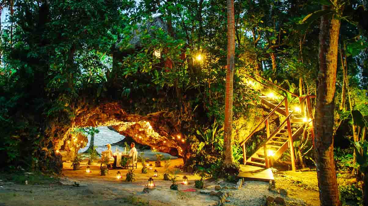 Candlelit table in a seaside cave at Namale Resort
