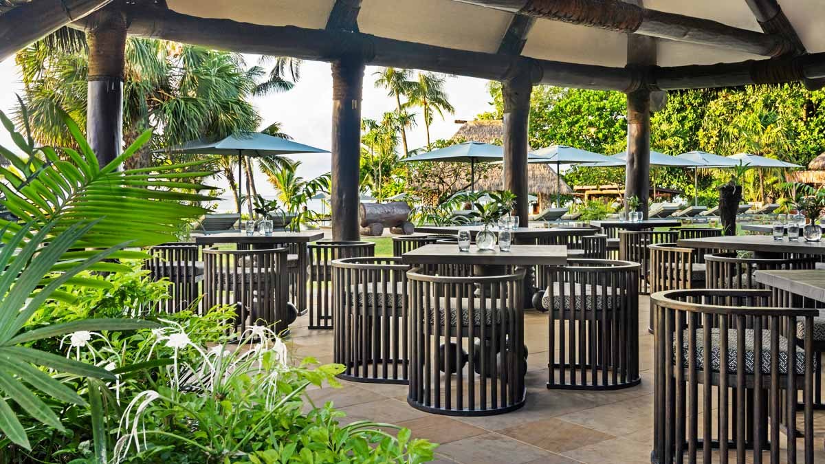 Open-sided restaurant terrace overlooking tropical gardens at Nanuku Resort Fiji