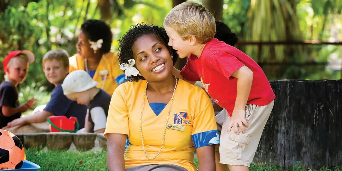 Children with resort carers in a shaded outdoor play area at Outrigger Fiji Beach Resort