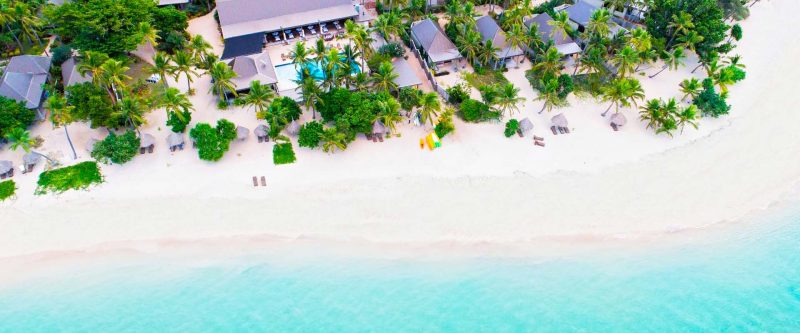 Aerial view of the beachfront and turquoise water at Paradise Cove Resort