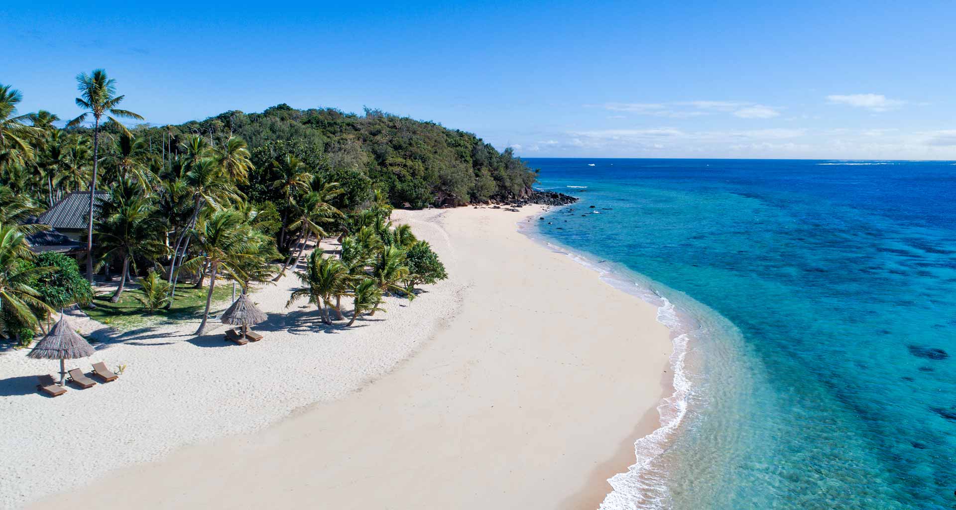 White-sand beach and blue water at Paradise Cove Resort in the Yasawa Islands