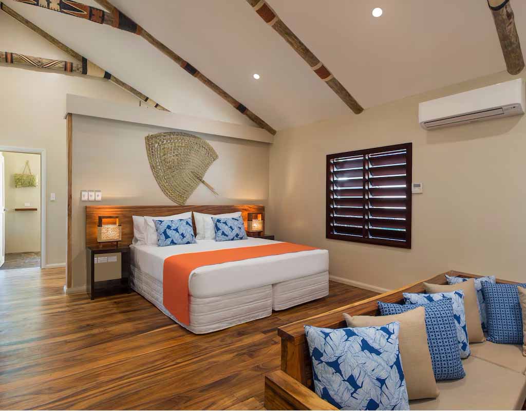 Bedroom and lounge seating in a Cove Villa at Paradise Cove Resort