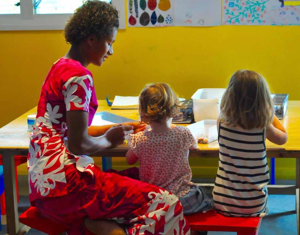 Children enjoying an activity with a team member at Paradise Cove Resort Kids Club