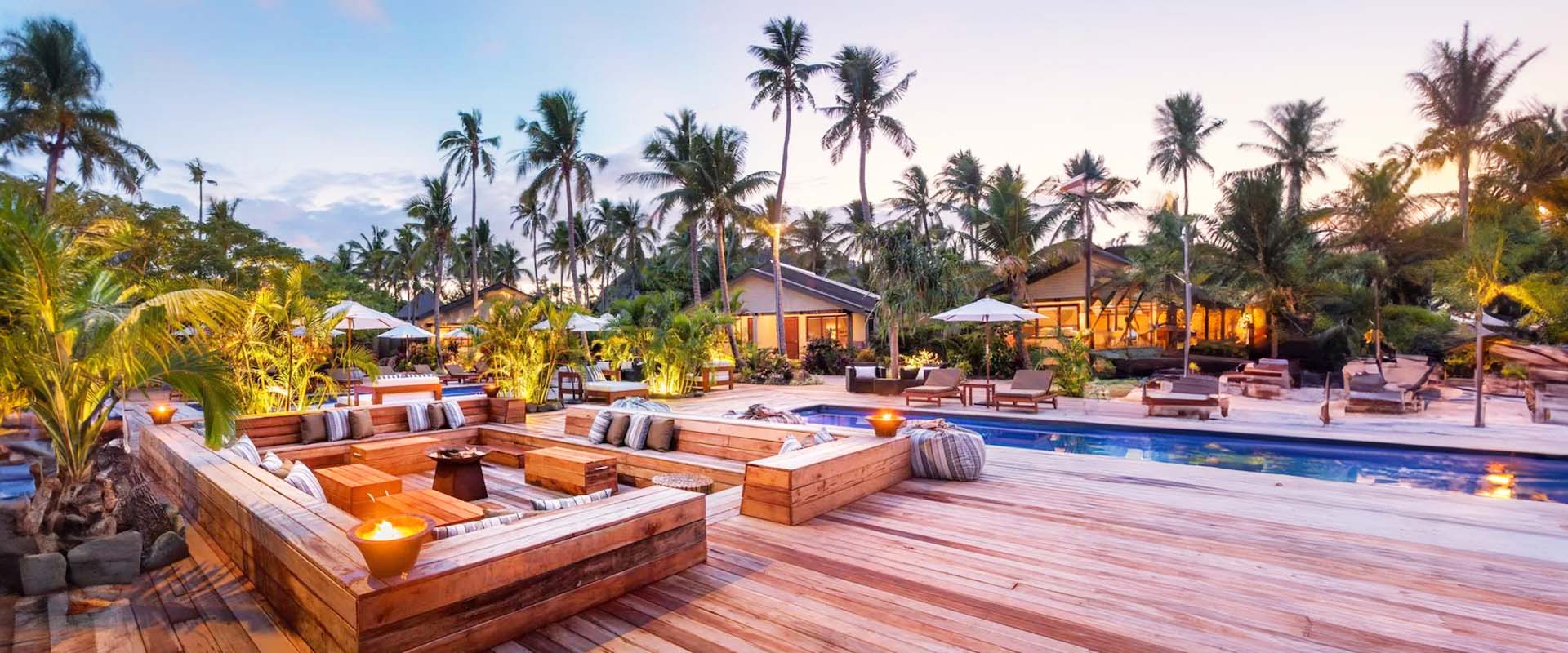 Beachside pool and deck at dusk at Paradise Cove Resort