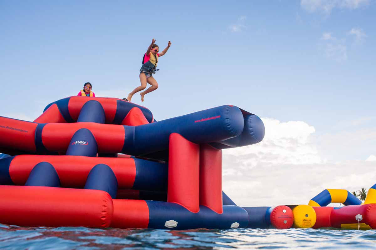 Children wearing life jackets at Plantation Island Resort’s inflatable water park