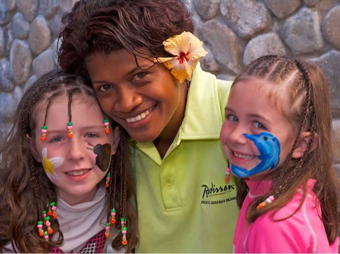 Resort team member with children after face painting at Radisson Blu Fiji