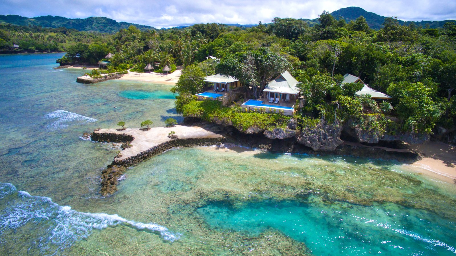 Clifftop villas and small coves along the shore of Savasi Island