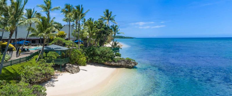 Beach, palms and clear lagoon at Shangri-La Yanuca Island, Fiji
