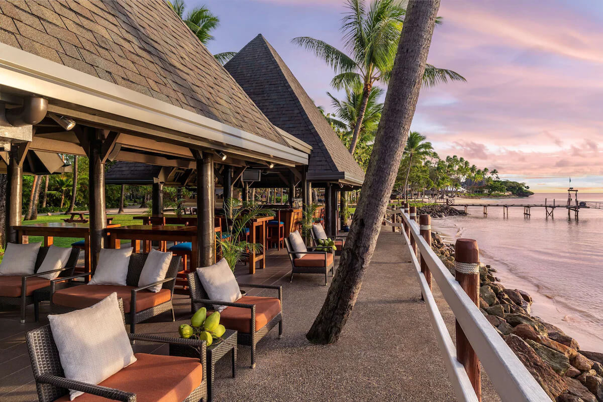 Open-air waterfront dining at sunset at Shangri-La Yanuca Island, Fiji