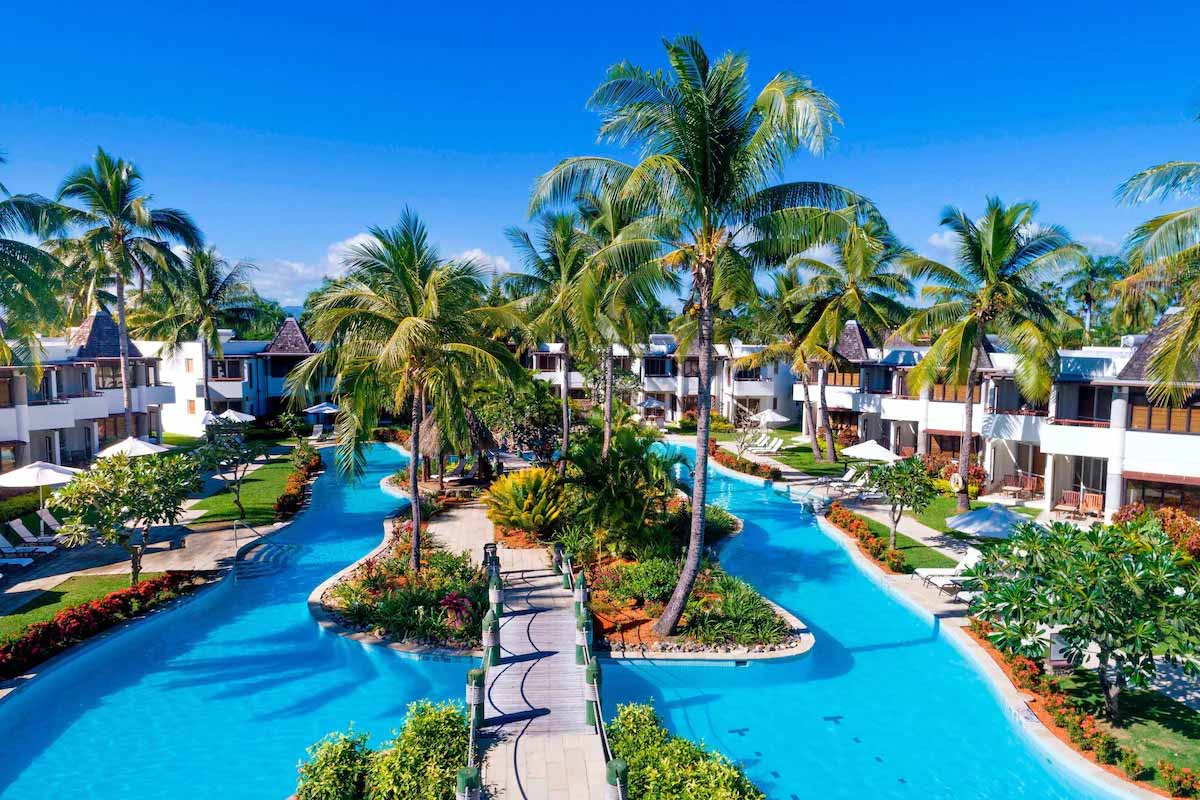 Lagoon-style pool winding between accommodation at Sheraton Denarau Villas