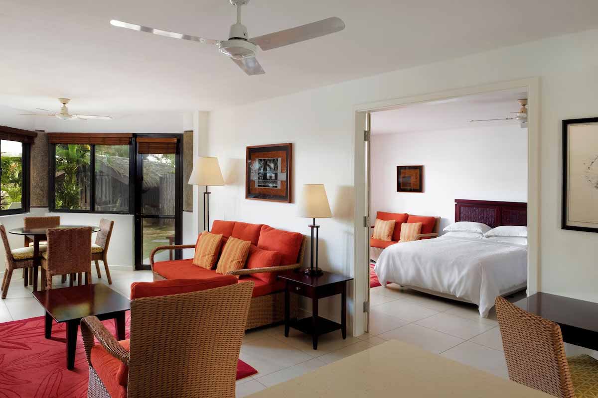 Living and dining area beside a bedroom at Sheraton Denarau Villas