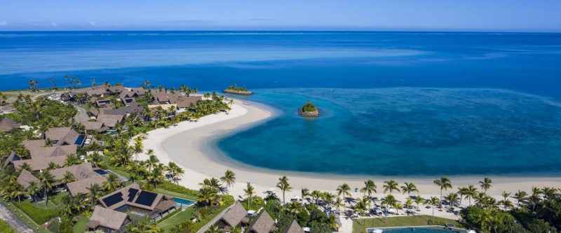 Aerial view of Six Senses Fiji, its curved beach and pool villas on Malolo Island