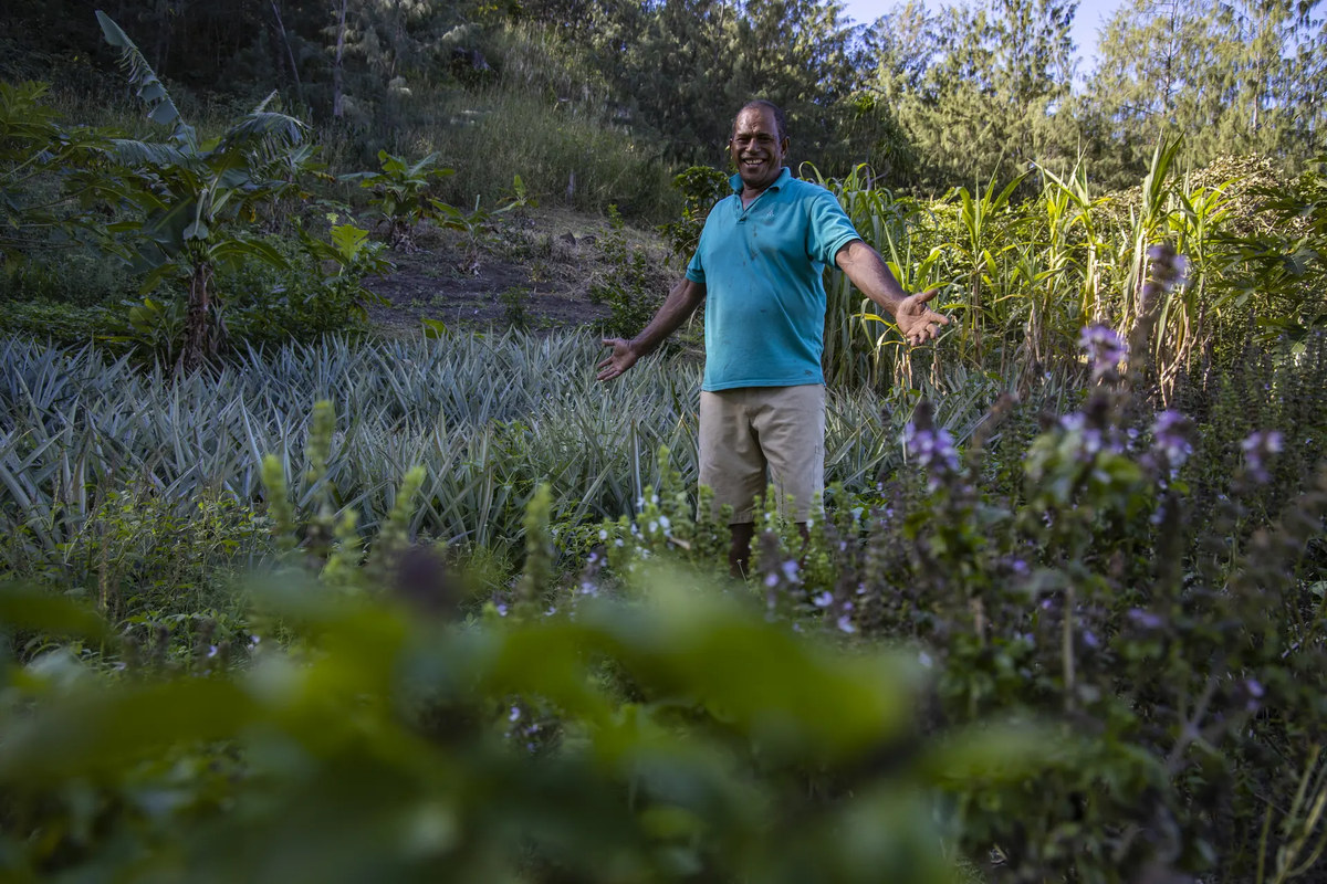 A Six Senses Fiji team member in the resort garden