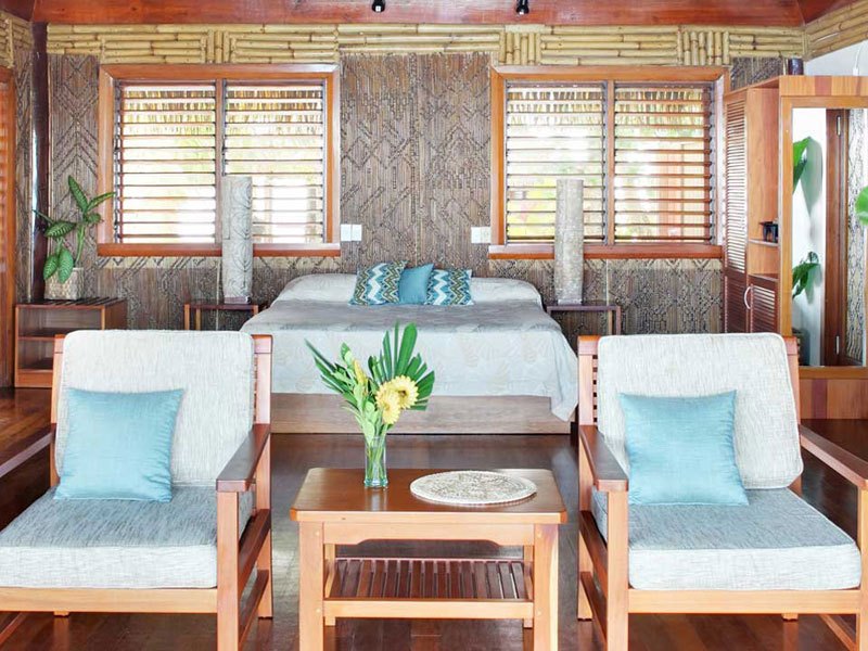 Natural timber interior of a Deluxe Bure at Toberua