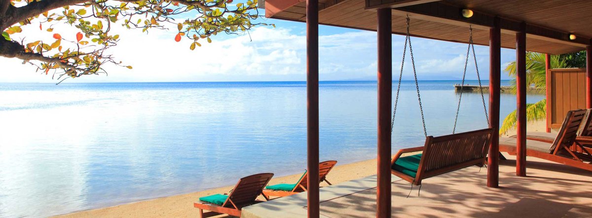 Oceanfront terrace and swing seat at Toberua