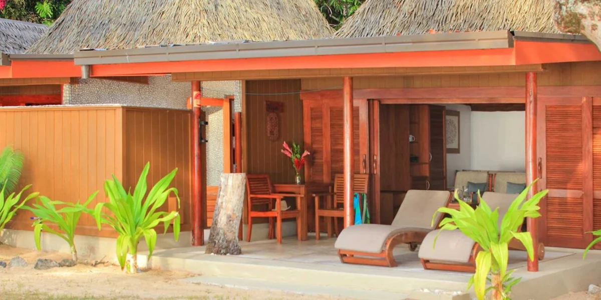 Covered deck and loungers outside a Tropical Oceanfront Bure at Toberua Island Resort