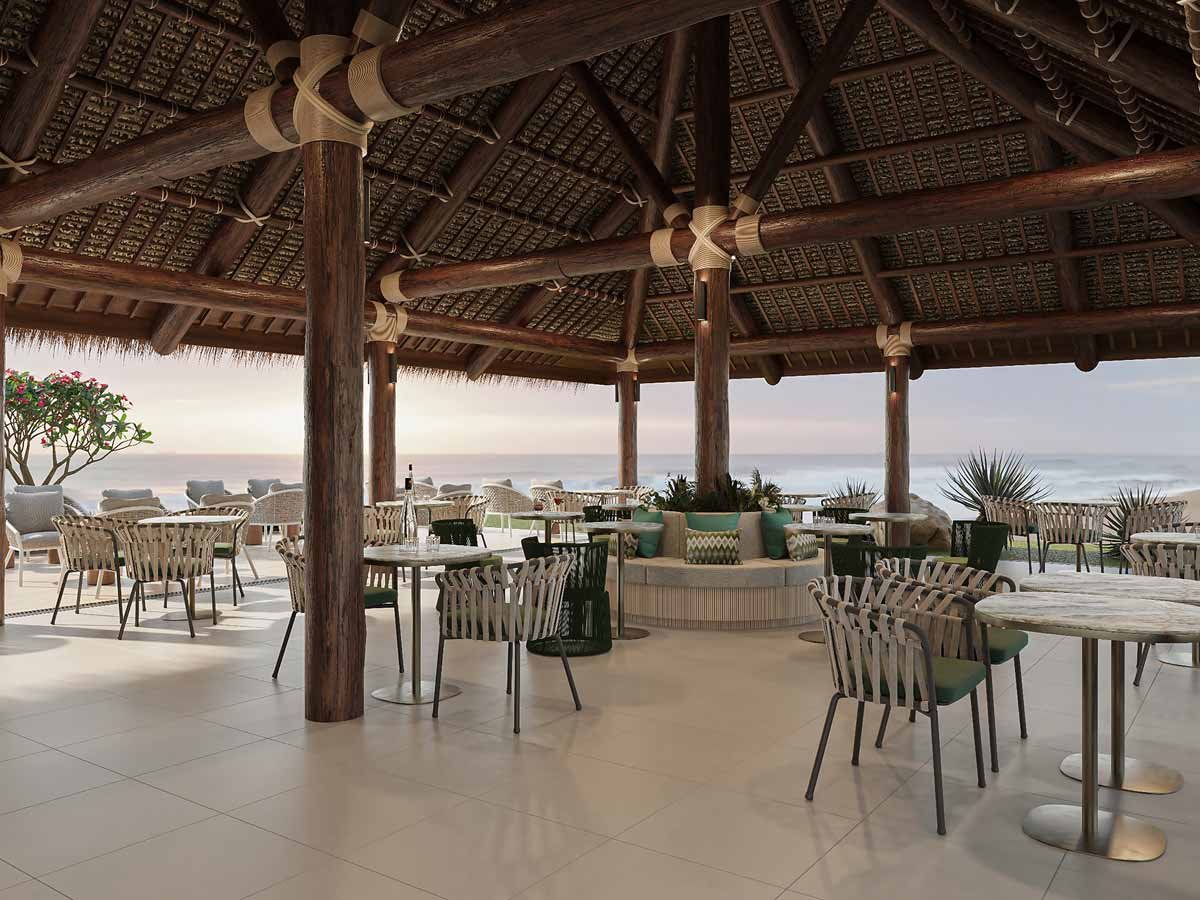 Open-air restaurant tables overlooking the sea at Tropica Island Resort