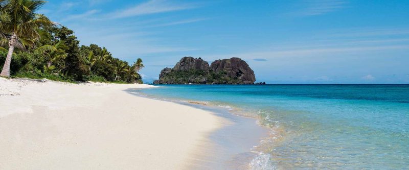 White sand beach and clear sea looking towards Vomo Lailai at VOMO Island Resort