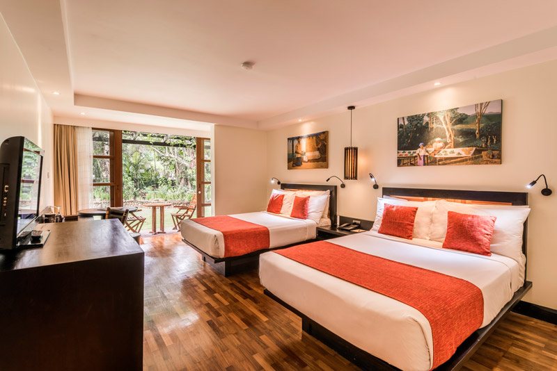 Guest bedroom with two beds and a garden-facing outlook at The Warwick Fiji