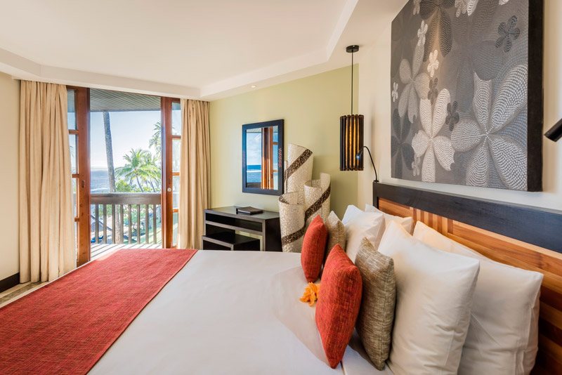 Guest bedroom with a balcony at The Warwick Fiji