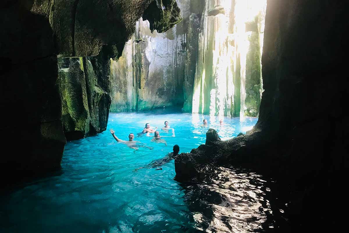 Swimmers inside the sunlit Sawa-i-Lau limestone caves on an excursion in the Yasawa Islands