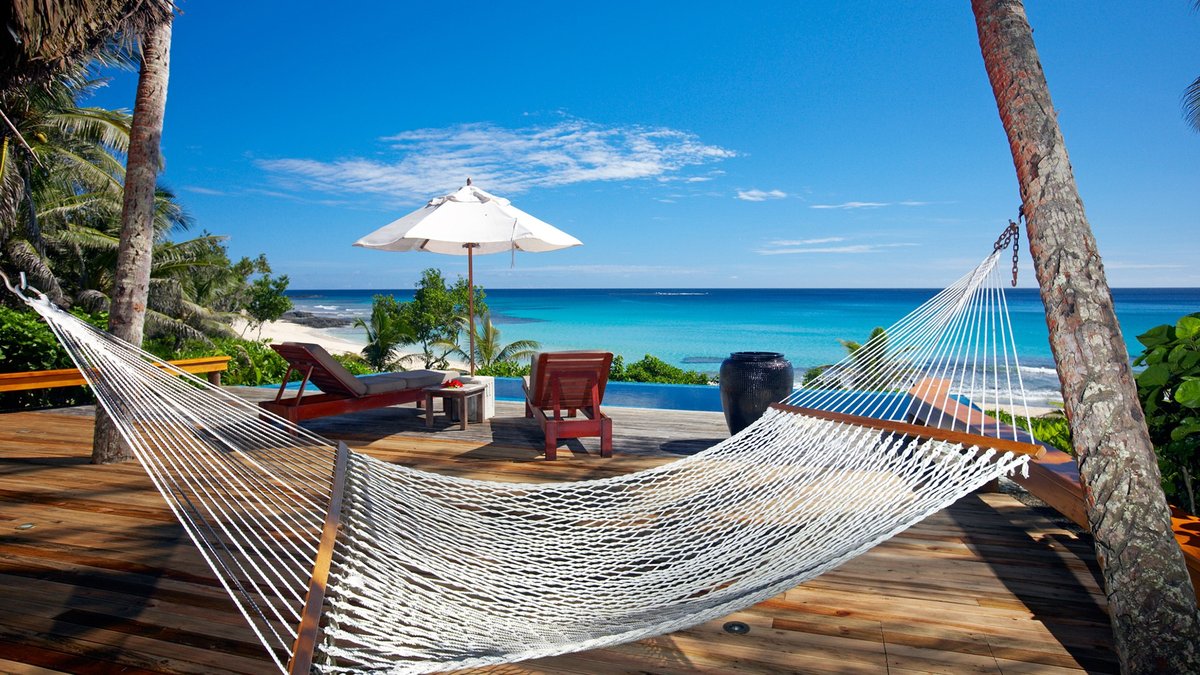 Hammock, private deck and pool overlooking the beach at Yasawa Island Resort’s Lomalagi Bure