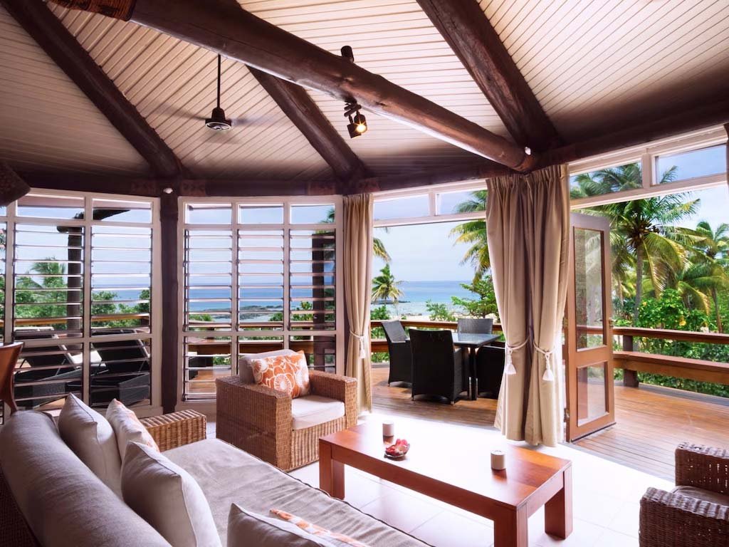 Living area and ocean-facing deck in the Two-Bedroom Bure at Yasawa Island Resort